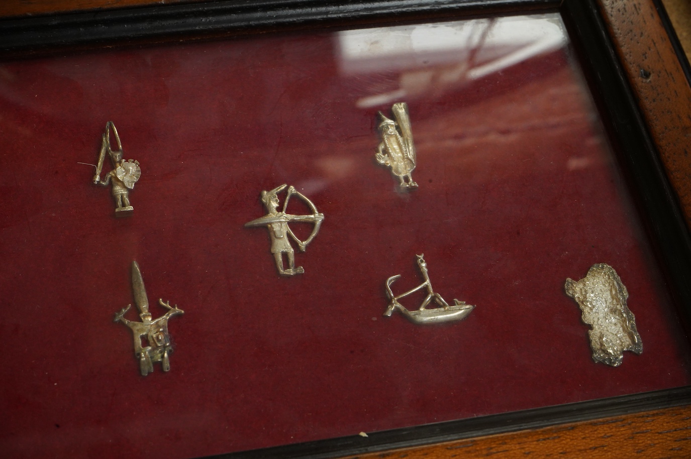 A Roman bronze badge, a medieval pewter badge and silver badges in the form of Sardinia emblems all framed., Swan badge 6cm wide, not including mount or frame. (Requires provenance)